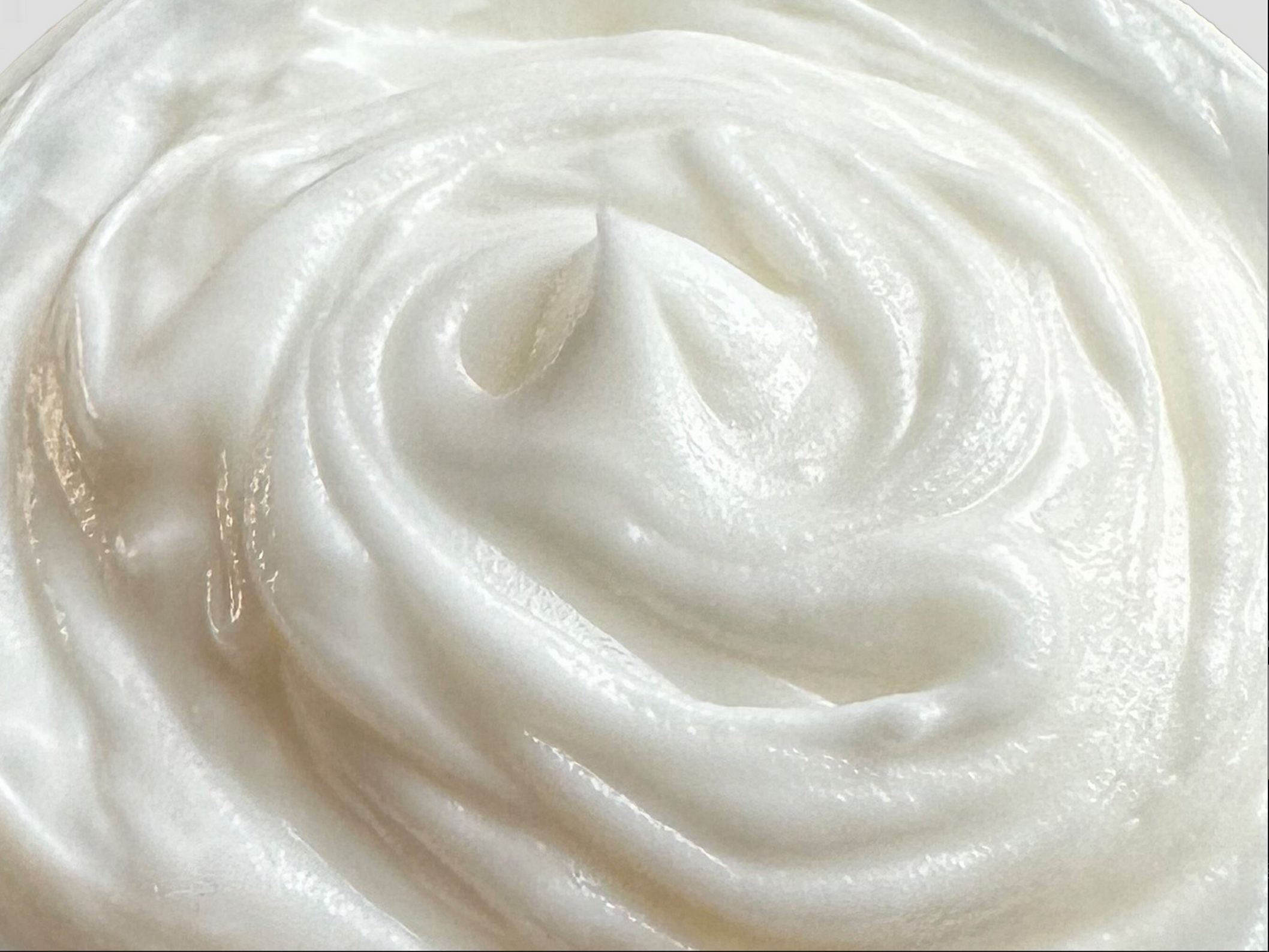 Close-up of whipped pure tallow moisturiser texture. Our grass-fed beef tallow cream offers easy application and rich nourishment. Packed with beneficial fatty acids, it promotes skin elasticity and firmness. Suitable for all skin types, including eczema-prone skin.